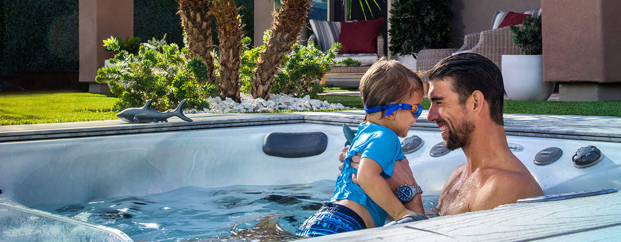 Phelps with his son boomer enjoying their swim spa
